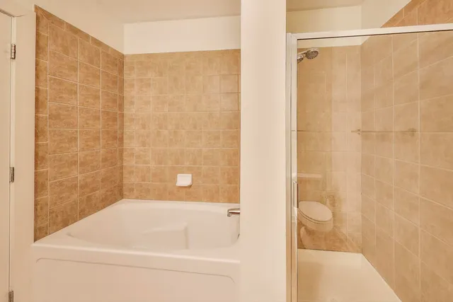 a bathroom with a shower and a bath tub