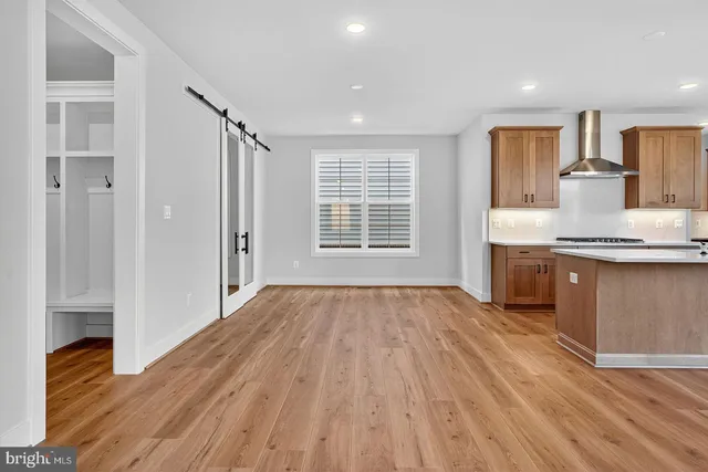 a view of kitchen with granite countertop cabinets and wooden floor