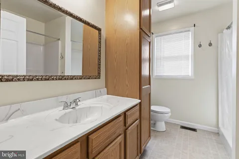 a bathroom with a sink toilet and mirror