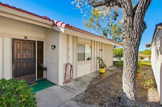 a living room with furniture a flat screen tv and a large window