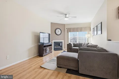 a living room with furniture a fireplace and a window
