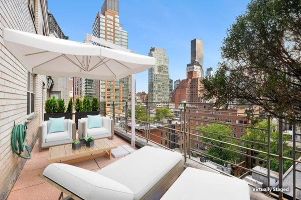 a view of a patio with couches table and chairs and potted plants
