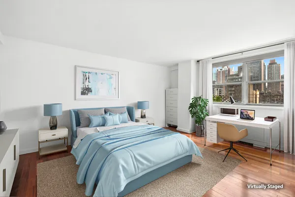 a bed room with a bed and a chair