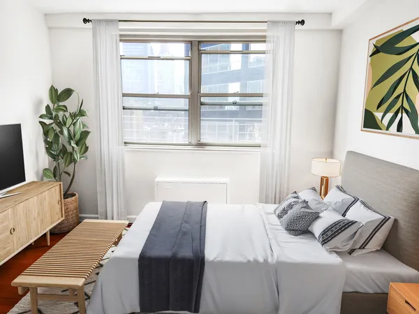 a bedroom that has a bed and a window in it
