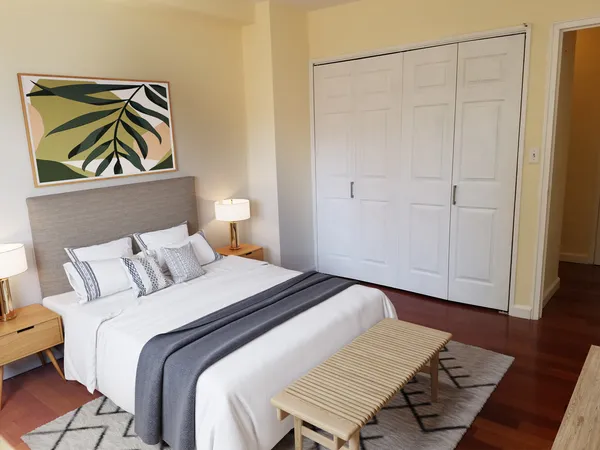 a bedroom that has a bed and a painting on the wall