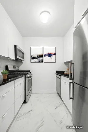 a kitchen with granite countertop a sink stove and refrigerator