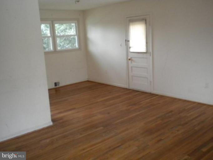 12500 Barbara Road Silver Spring, MD 20906 - Photo 3 of 11 an empty room with wooden floor and windows