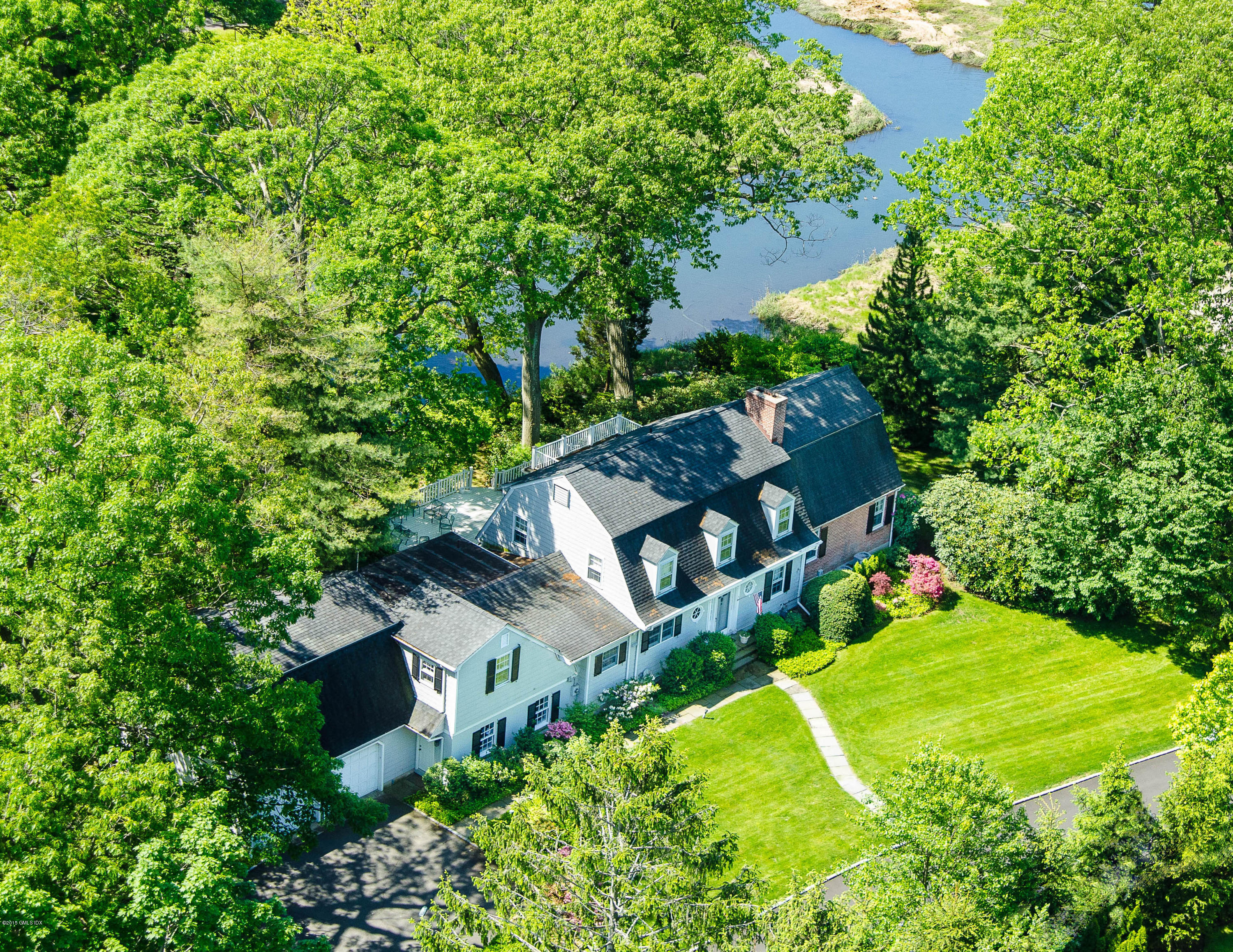 an aerial view of a house with a yard basket ball court and outdoor seating