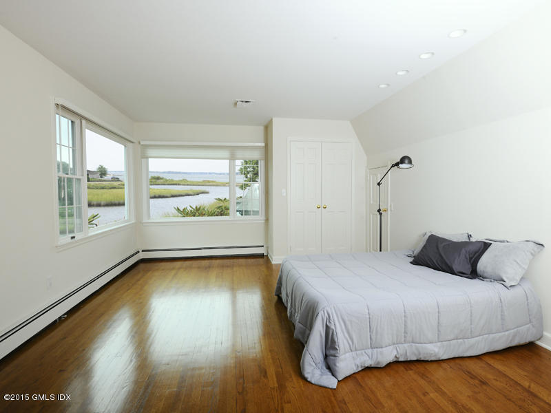 8 Indian Point Lane Riverside, CT 06878 - Photo 14 of 18 a bedroom with a bed and wooden floor
