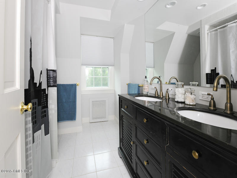 8 Indian Point Lane Riverside, CT 06878 - Photo 17 of 18 a spacious bathroom with a granite countertop sink and a mirror