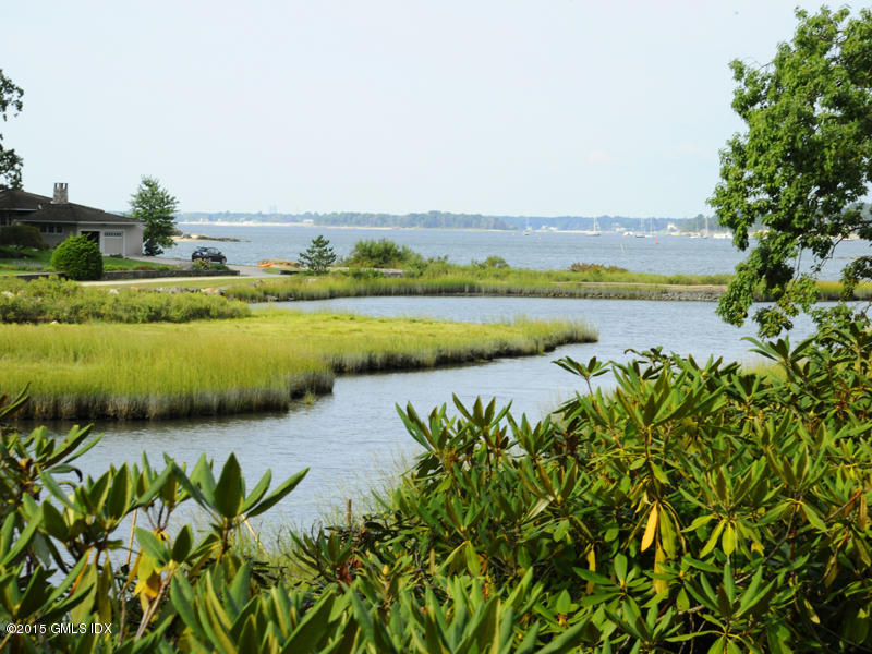 8 Indian Point Lane Riverside, CT 06878 - Photo 3 of 18 a view of a lake with a beach