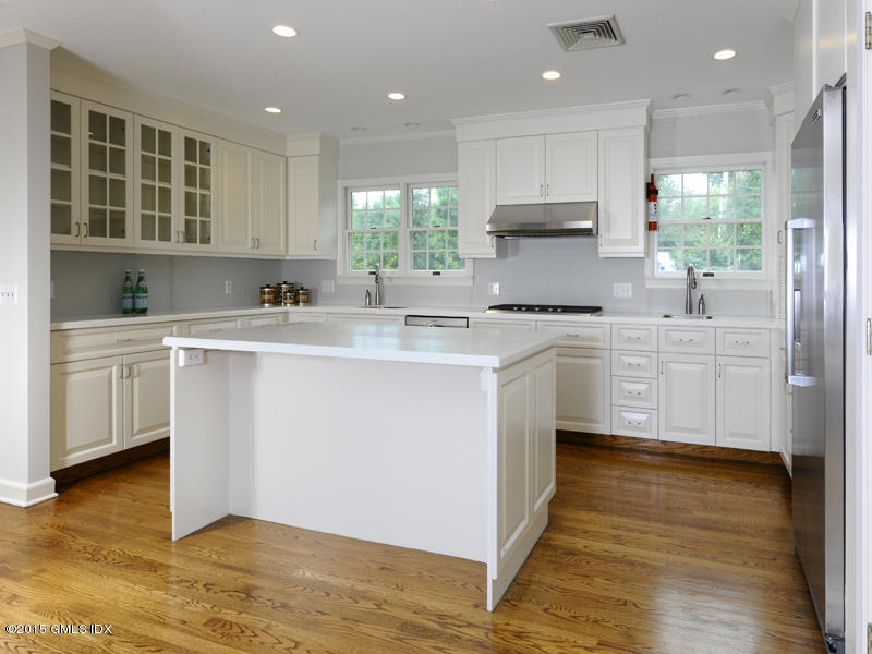 8 Indian Point Lane Riverside, CT 06878 - Photo 9 of 18 a kitchen with stainless steel appliances granite countertop a sink a stove a refrigerator cabinets and wooden floor