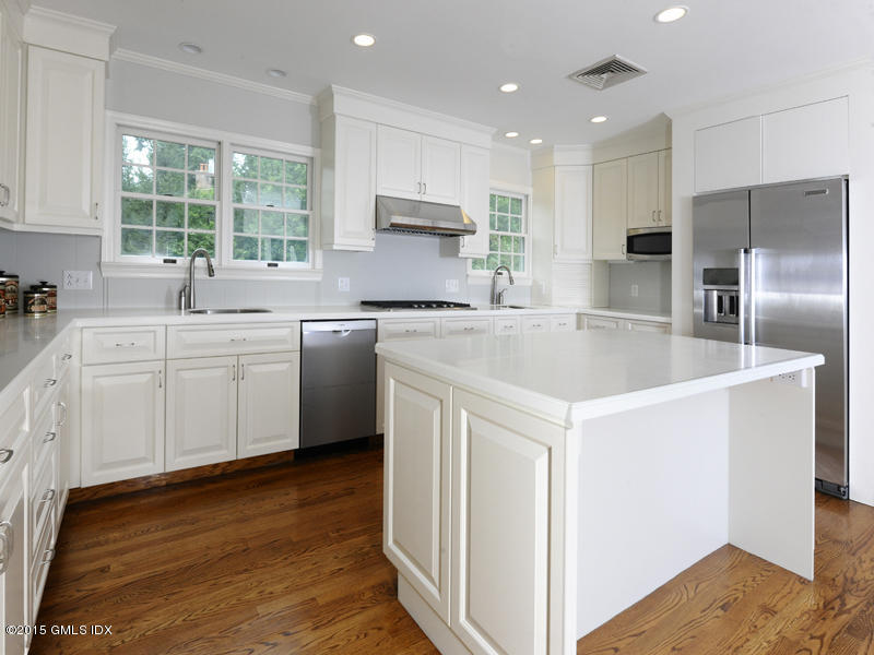 8 Indian Point Lane Riverside, CT 06878 - Photo 10 of 18 a kitchen with stainless steel appliances a sink a stove a refrigerator cabinets and a window