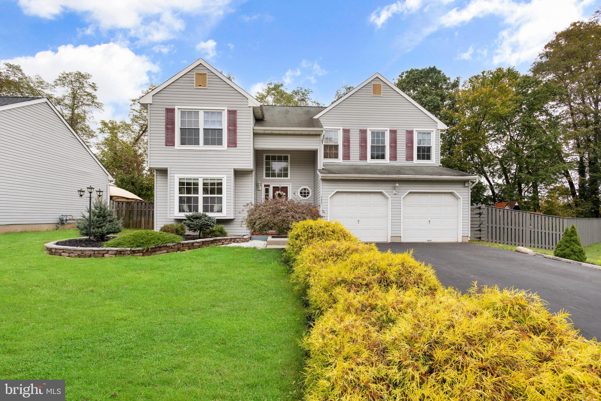 135 Cornflower Road Trenton, NJ 08620 - Photo 1 of 31 a front view of a house with a garden and yard