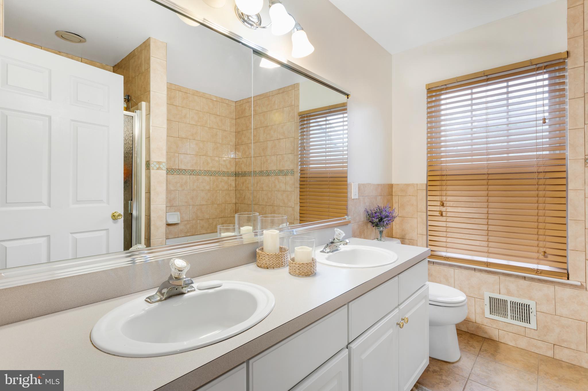 135 Cornflower Road Trenton, NJ 08620 - Photo 23 of 31 a bathroom with a granite countertop sink toilet and large mirror