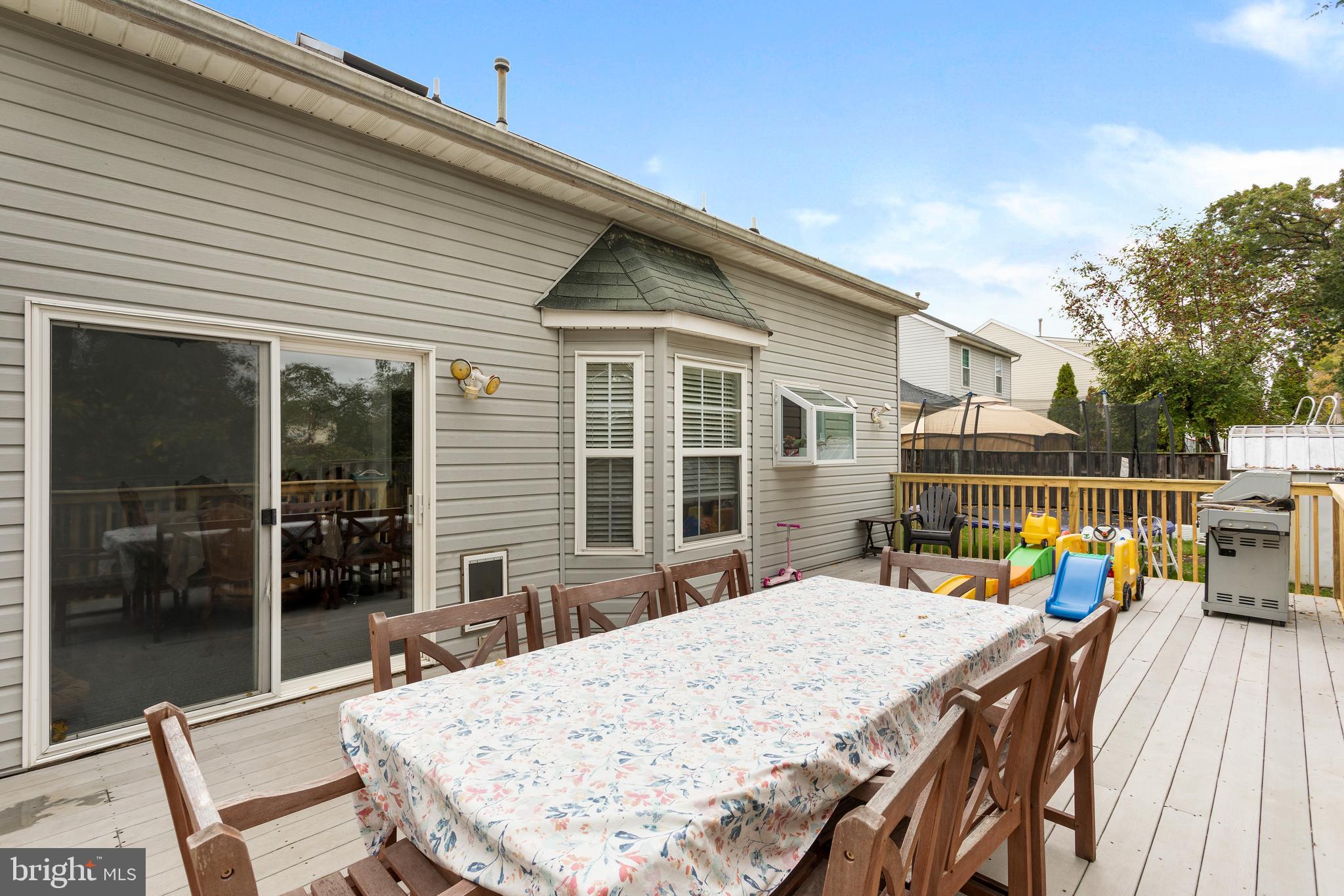 135 Cornflower Road Trenton, NJ 08620 - Photo 5 of 31 a view of a patio with table and chairs with wooden floor and fence
