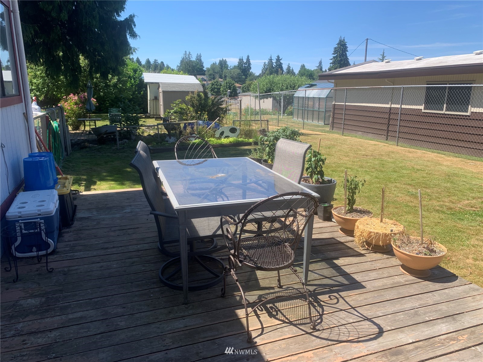12419 Military Road South Seattle, WA 98168 - Photo 8 of 24 a view of a patio with table and chairs and potted plants