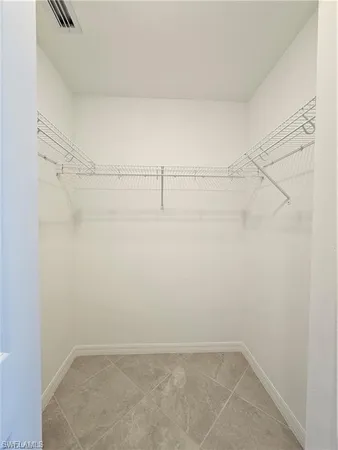 a bathroom with a double vanity sink and mirror with toilet