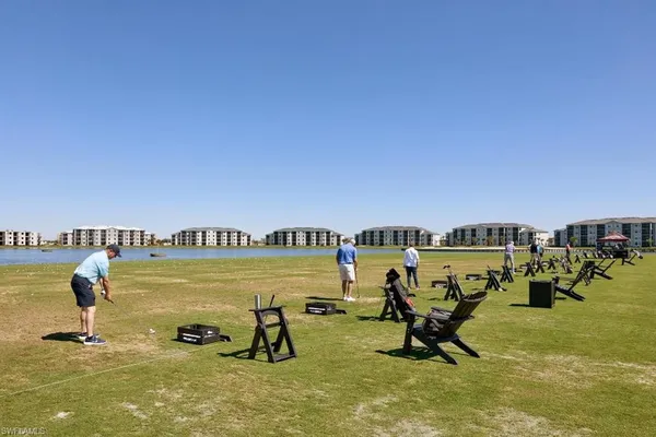 a view of swimming pool with outdoor seating and yard in the back
