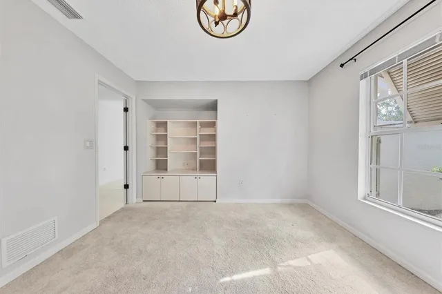 a view of a yard with plants and a fountain