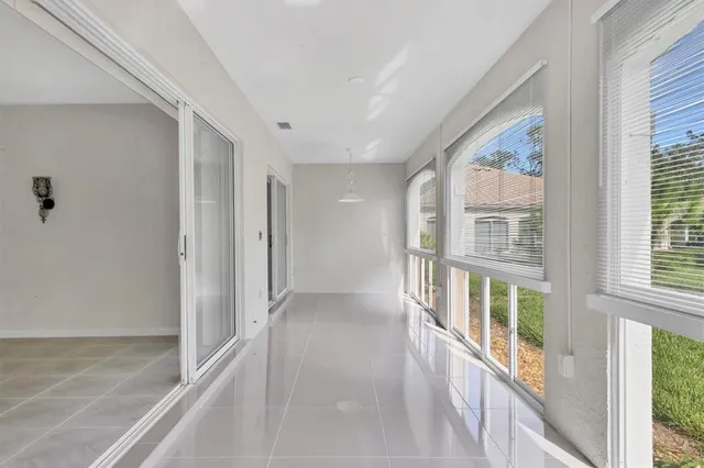an aerial view of a house with a yard and lake view