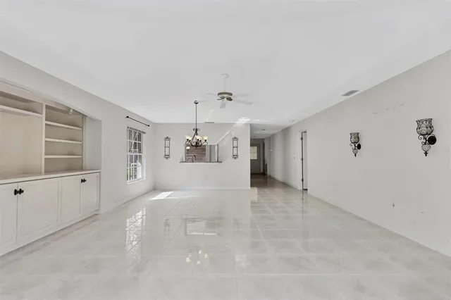 a kitchen with granite countertop a stove sink and microwave