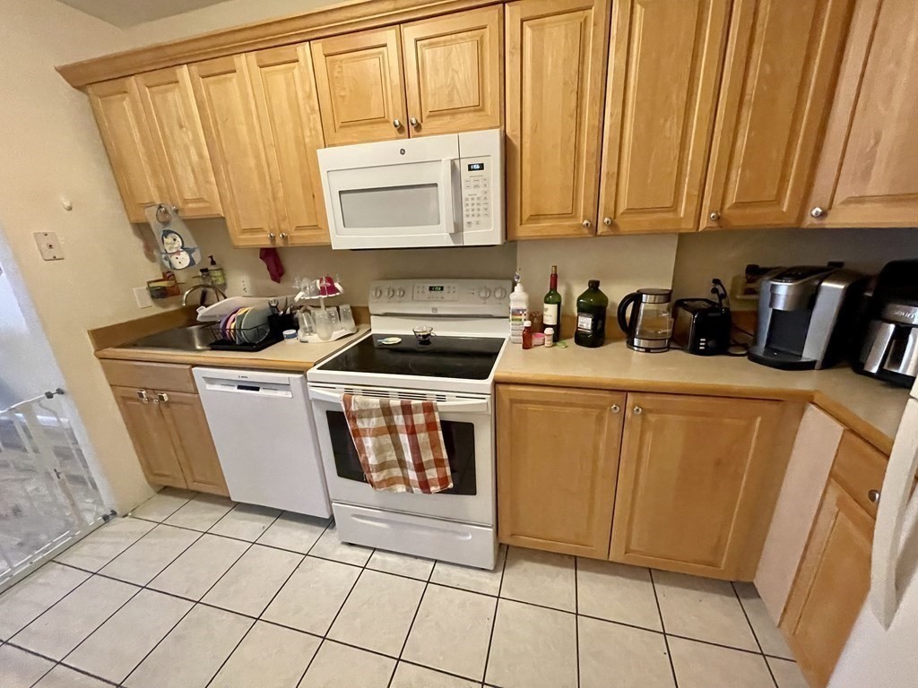 100 Marion Street, Unit 18 Brookline, MA 02446 - Photo 4 of 19 a white stove top oven sitting inside of a kitchen