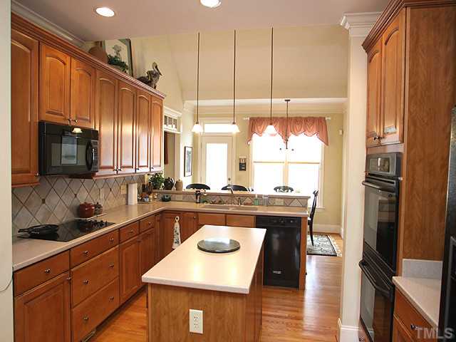 212 Waterville Street Raleigh, NC 27603 - Photo 5 of 13 a kitchen with a stove a refrigerator and a sink