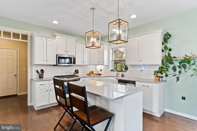 a store room with lots of clutter and stainless steel appliances