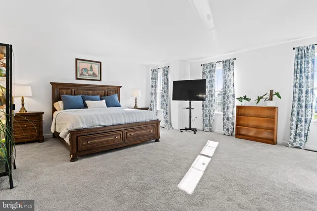 a bedroom with a bed and a potted plant