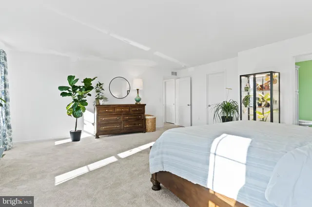 a bedroom with a bed window and a flat screen tv