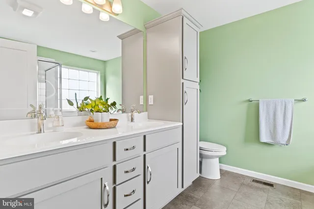 a white bath tub sitting in a bathroom next to a window