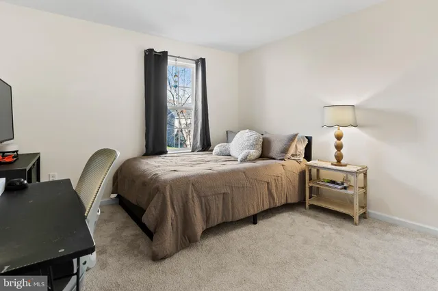 a bedroom with furniture and a flat screen tv