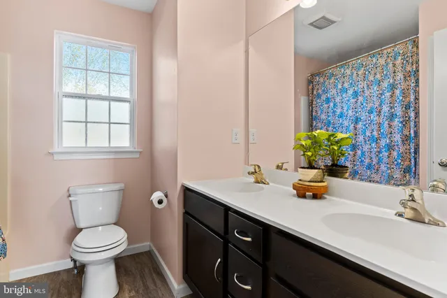 a bedroom with a bed and a flat tv screen on the dresser