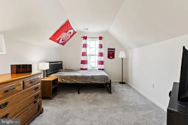 a bedroom with a bed and flat screen tv
