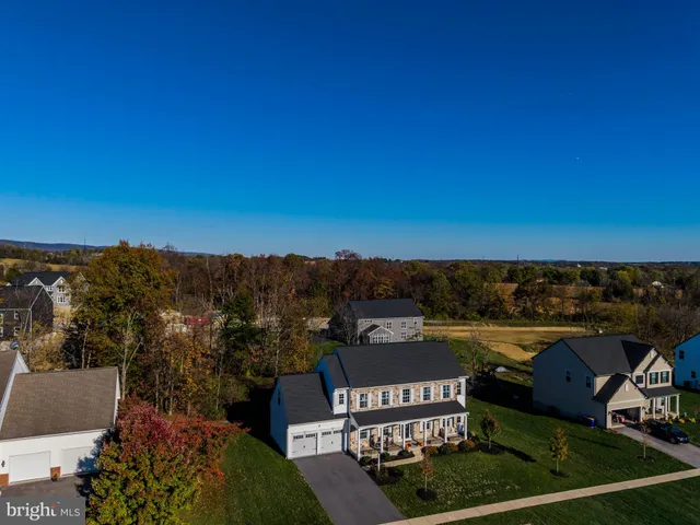 a backyard of a house with lots of plants and trees