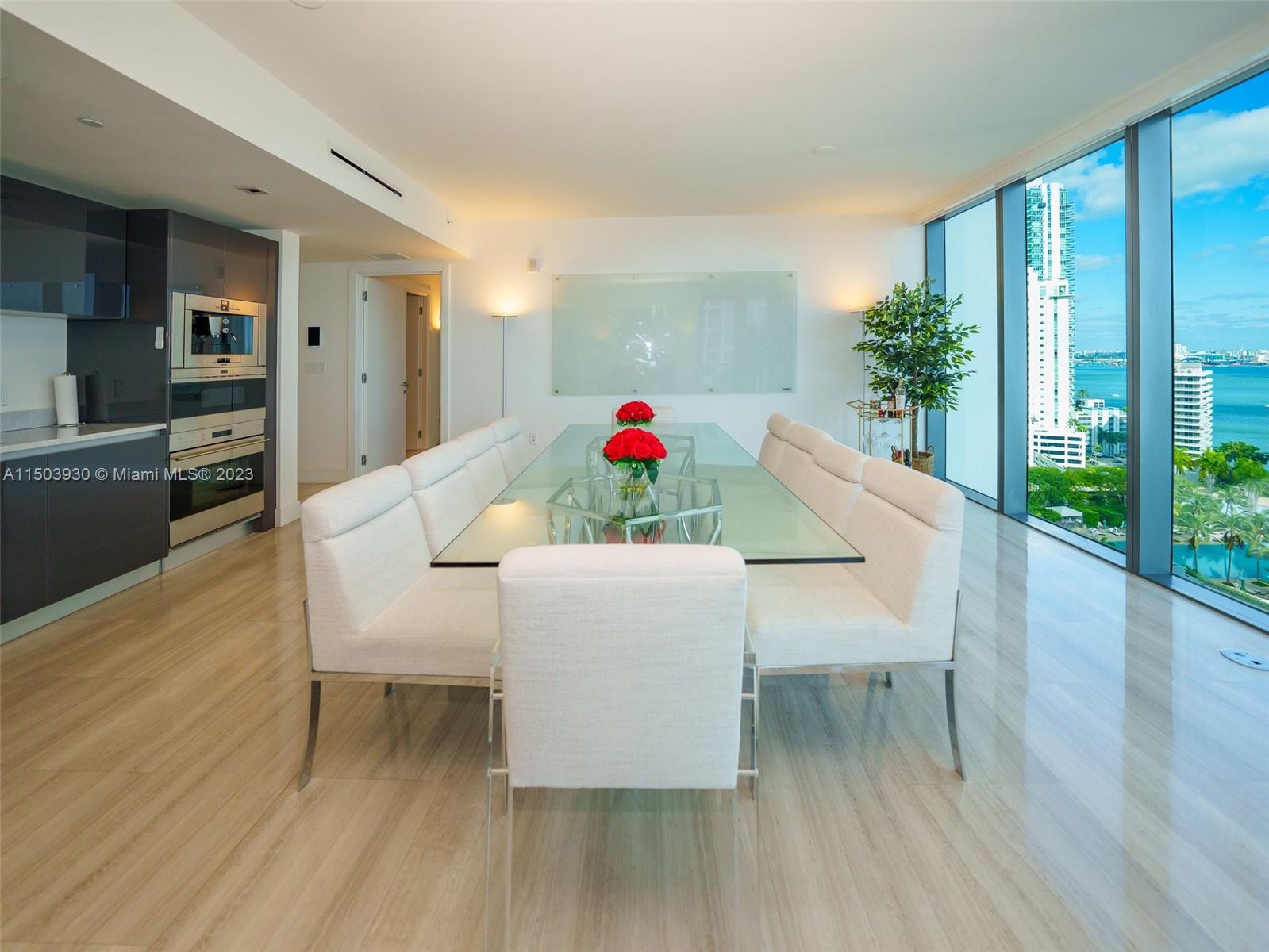 1451 Brickell Avenue, Unit 1803 Miami, FL 33131 - Photo 1 of 35 a living room with furniture and a wooden floor