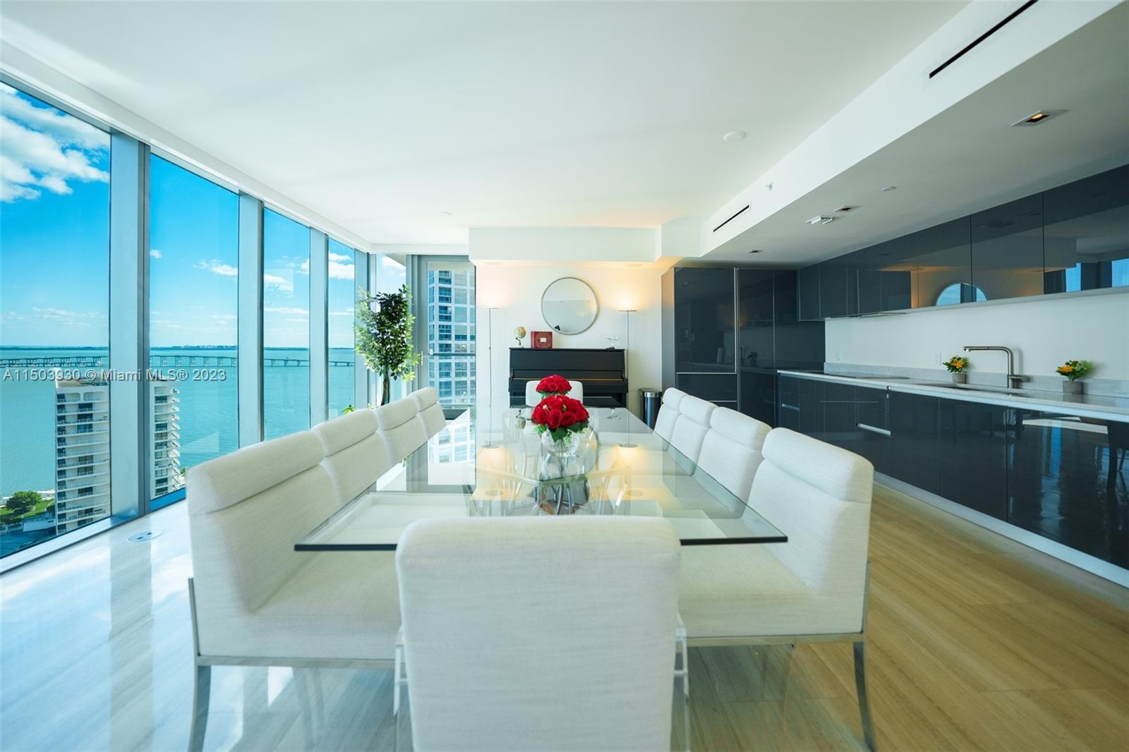 1451 Brickell Avenue, Unit 1803 Miami, FL 33131 - Photo 13 of 35 a living room with furniture and a large window