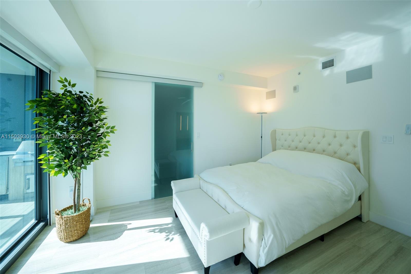 1451 Brickell Avenue, Unit 1803 Miami, FL 33131 - Photo 14 of 35 a bedroom with a bed and a potted plant