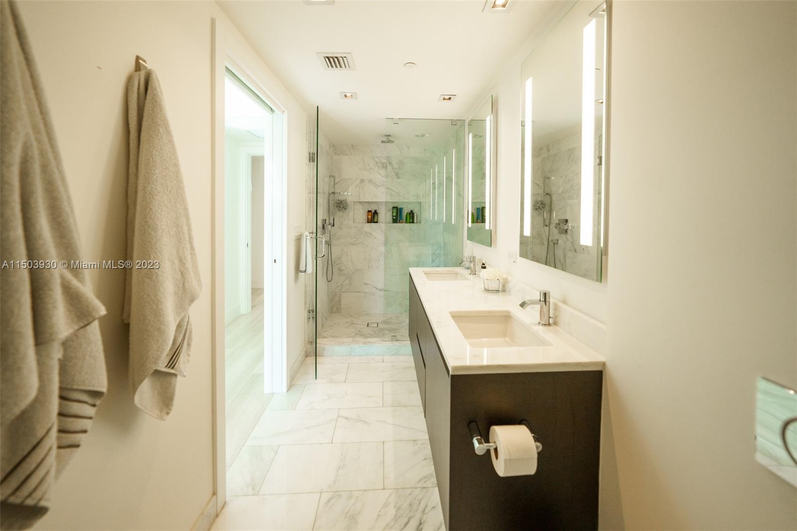 1451 Brickell Avenue, Unit 1803 Miami, FL 33131 - Photo 18 of 35 a en suite bathroom with a sink and a mirror