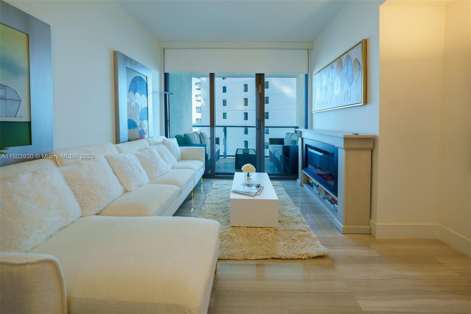 1451 Brickell Avenue, Unit 1803 Miami, FL 33131 - Photo 25 of 35 a living room with furniture and a fireplace