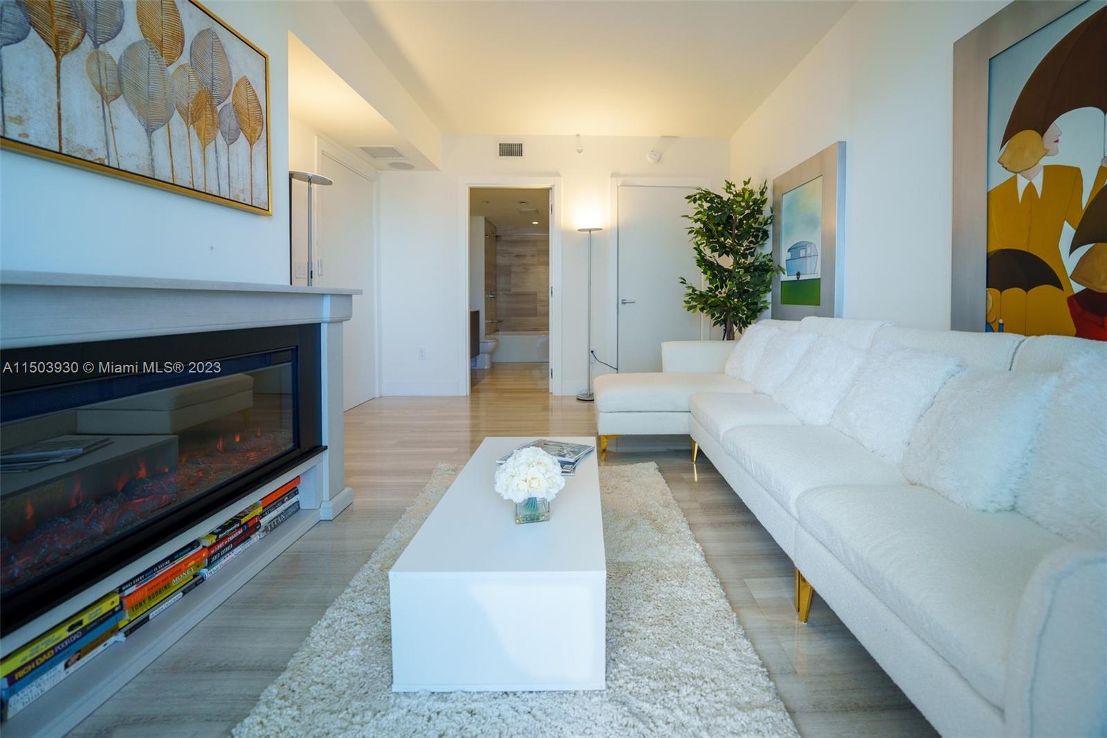 1451 Brickell Avenue, Unit 1803 Miami, FL 33131 - Photo 26 of 35 a living room with furniture and a fireplace