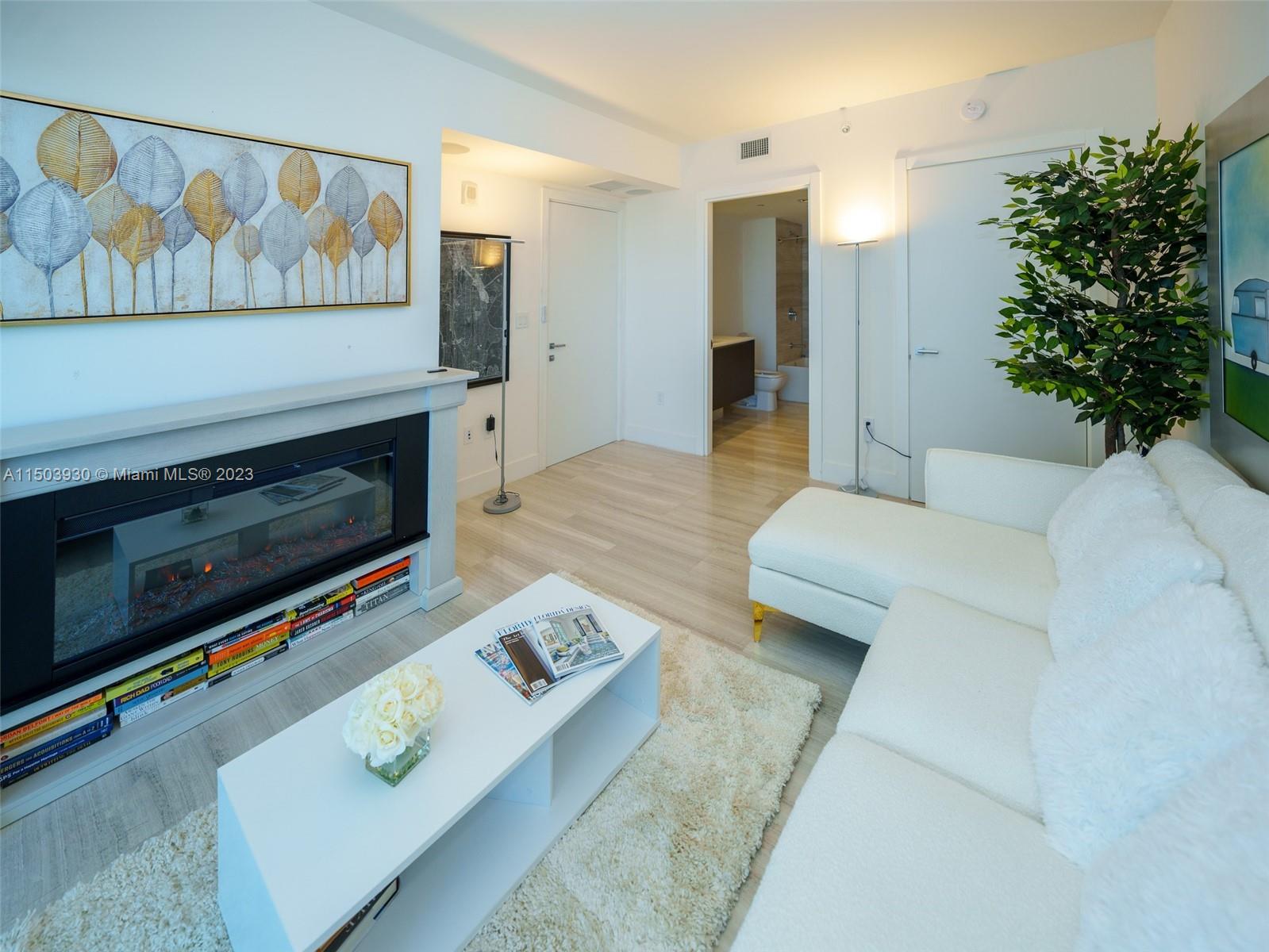 1451 Brickell Avenue, Unit 1803 Miami, FL 33131 - Photo 27 of 35 a living room with furniture and a fireplace