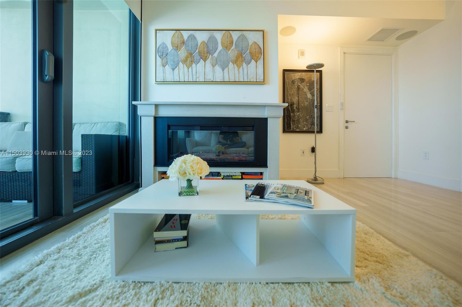 1451 Brickell Avenue, Unit 1803 Miami, FL 33131 - Photo 28 of 35 a dining room with furniture and a fireplace