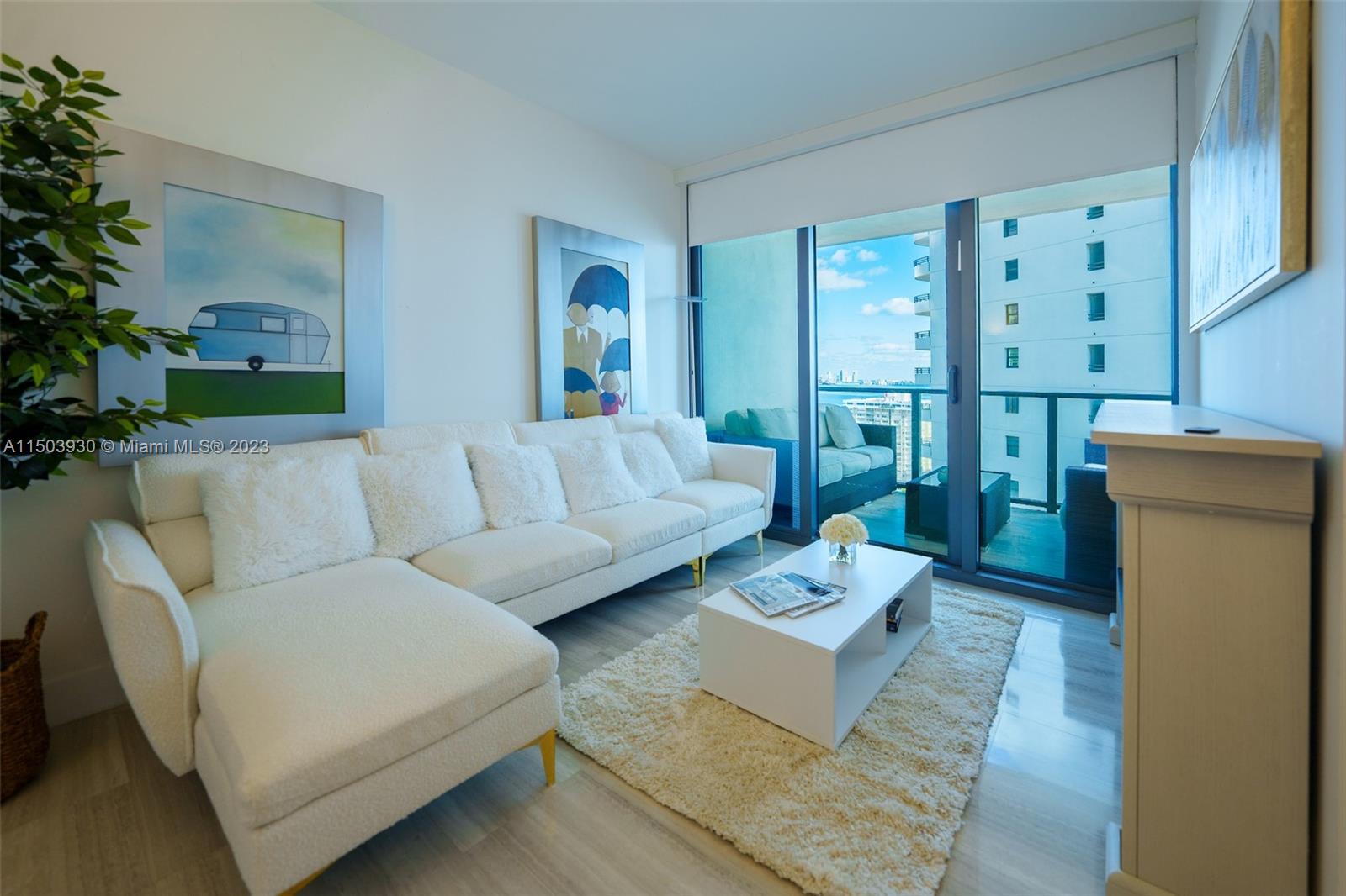 1451 Brickell Avenue, Unit 1803 Miami, FL 33131 - Photo 29 of 35 a living room with furniture and a large window