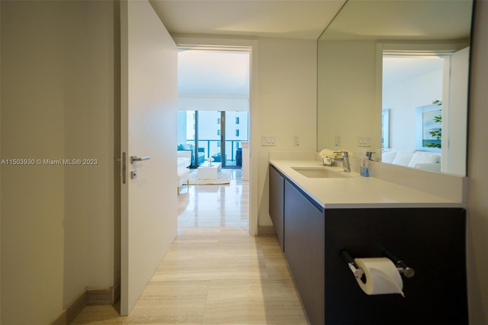 1451 Brickell Avenue, Unit 1803 Miami, FL 33131 - Photo 30 of 35 a bathroom with a sink and a mirror