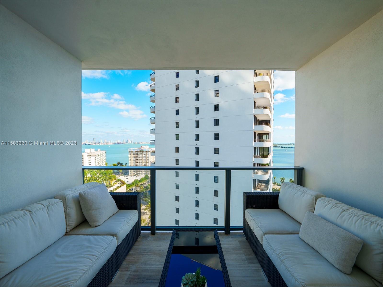 1451 Brickell Avenue, Unit 1803 Miami, FL 33131 - Photo 31 of 35 a living room with furniture and wooden floor