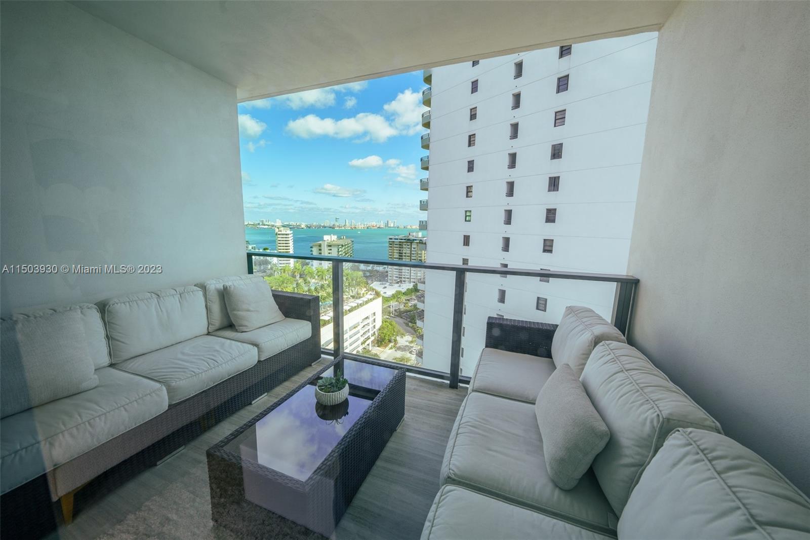 1451 Brickell Avenue, Unit 1803 Miami, FL 33131 - Photo 32 of 35 a living room with furniture and a large window