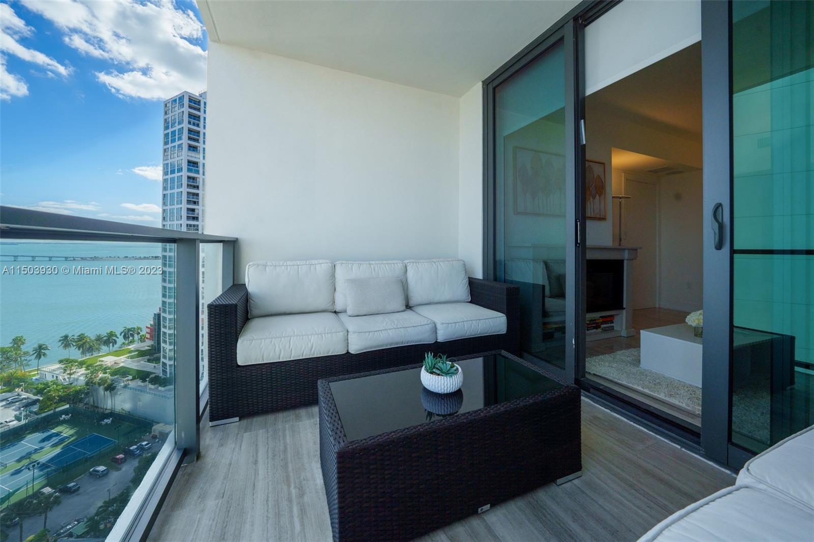 1451 Brickell Avenue, Unit 1803 Miami, FL 33131 - Photo 33 of 35 a living room with furniture and a potted plant