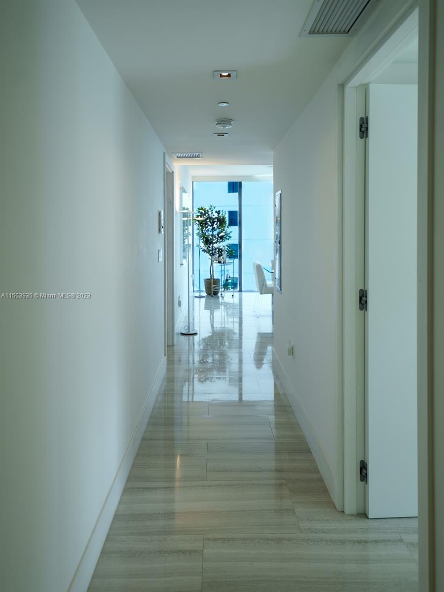 1451 Brickell Avenue, Unit 1803 Miami, FL 33131 - Photo 7 of 35 a view of a hallway with wooden floor and a dining room